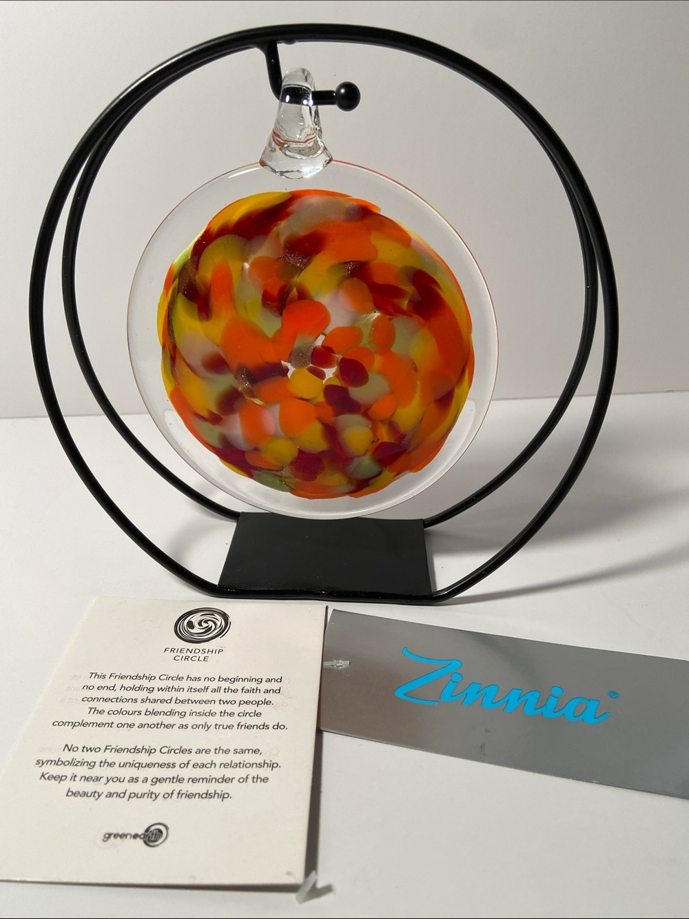 Zinnia hand-blown glass friendship circle features a vibrant red and orange